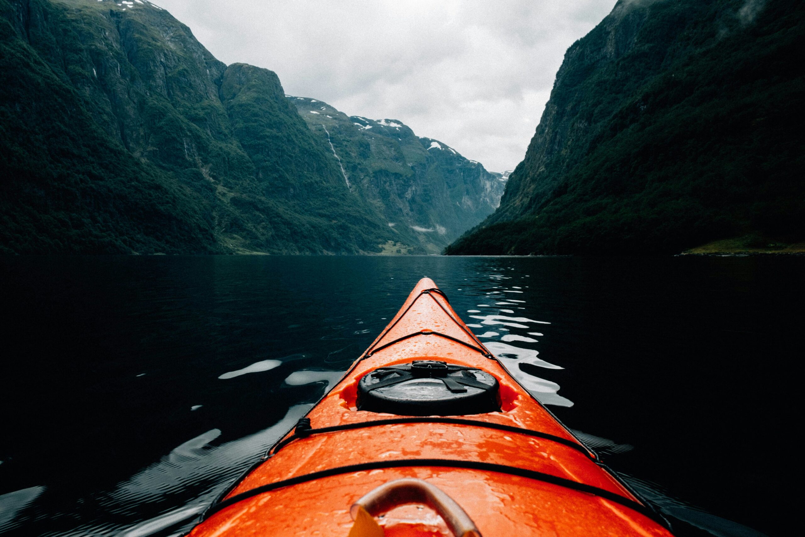 picture of an orange canoe on a lake